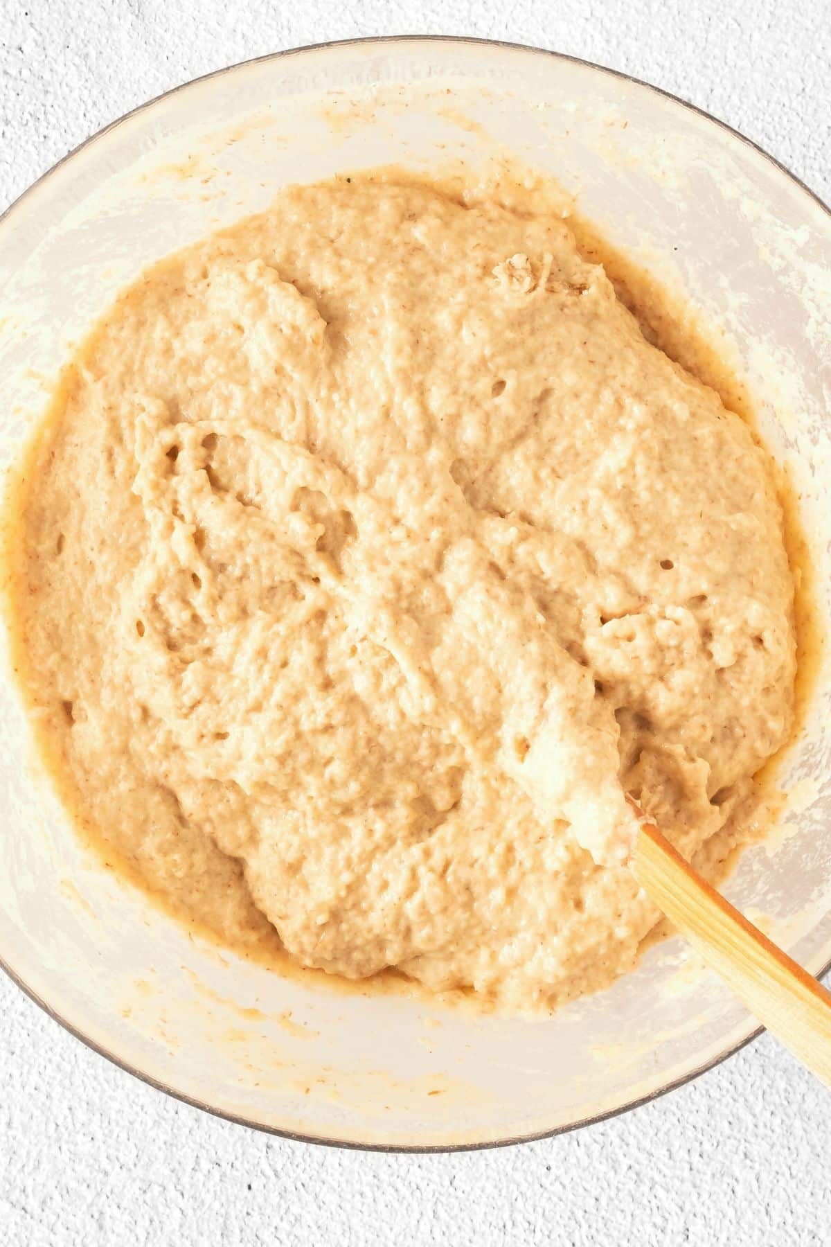 Gluten-free bread dough in glass bowl.