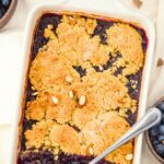 Top down view of half-eaten almond flour blueberry cobbler.