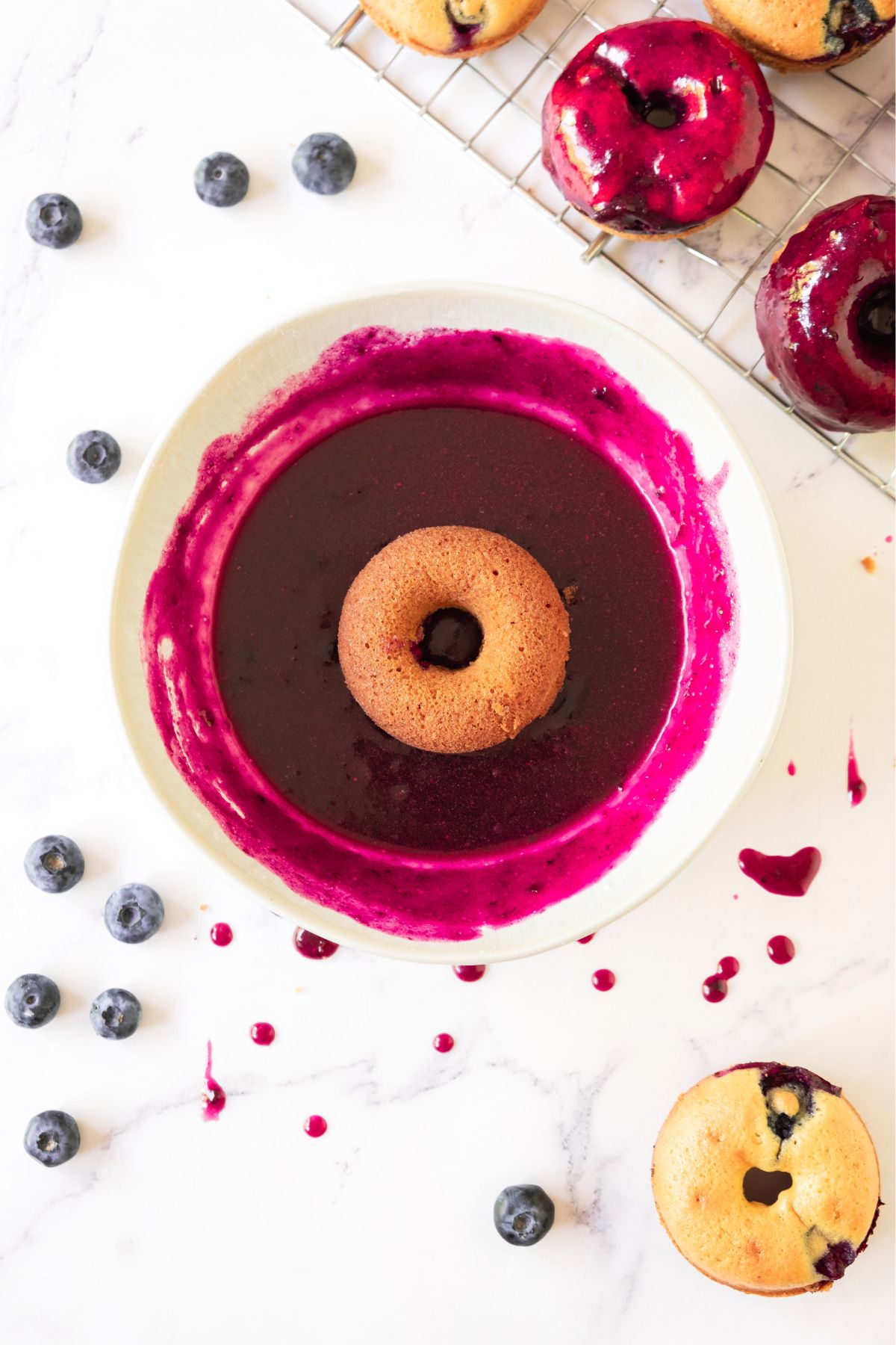 Donut in a bowl of blueberry glaze