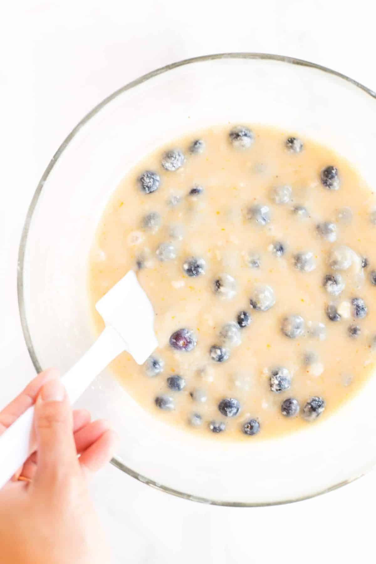 Folding blueberries into muffin batter
