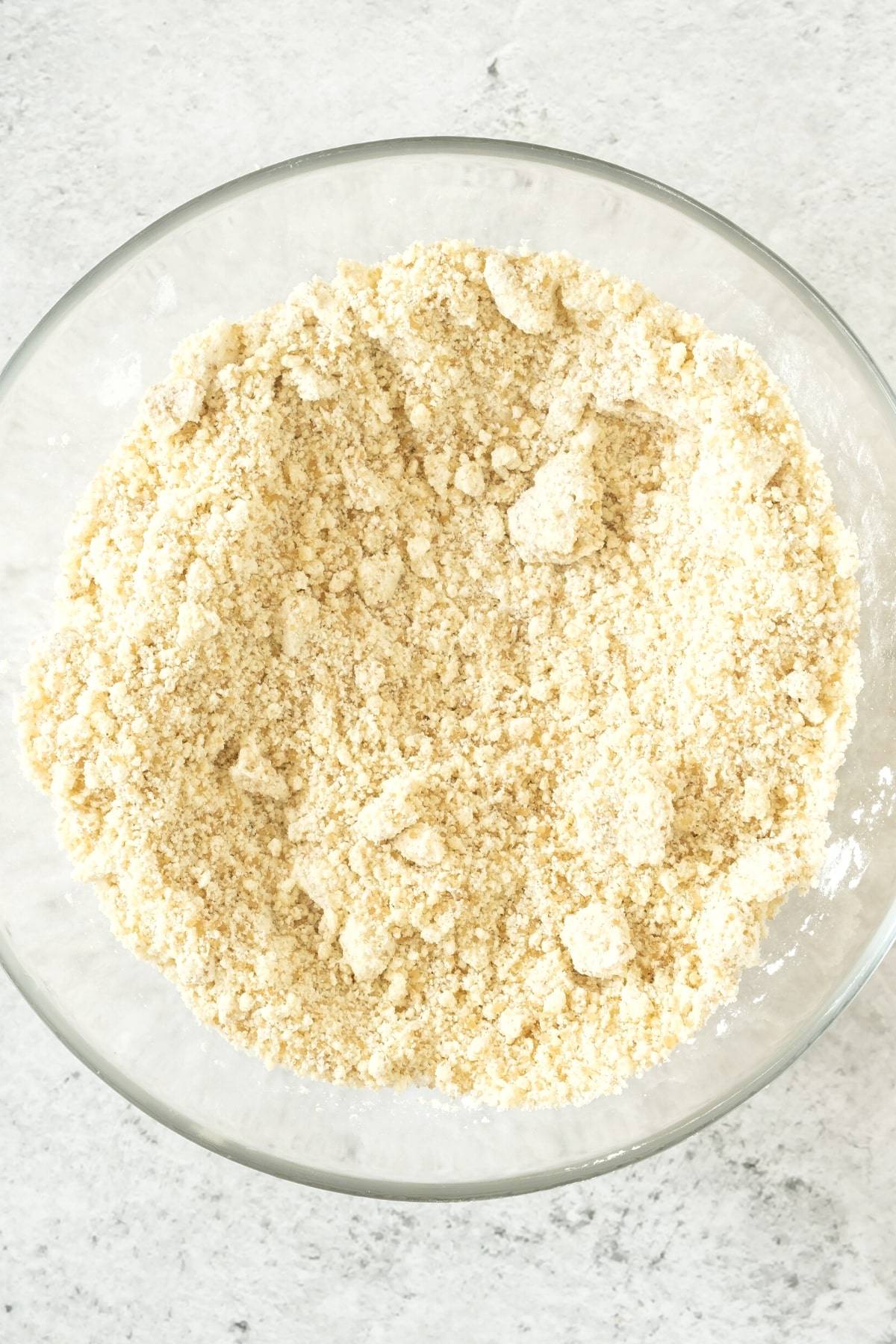 Flour mixture in a glass mixing bowl.