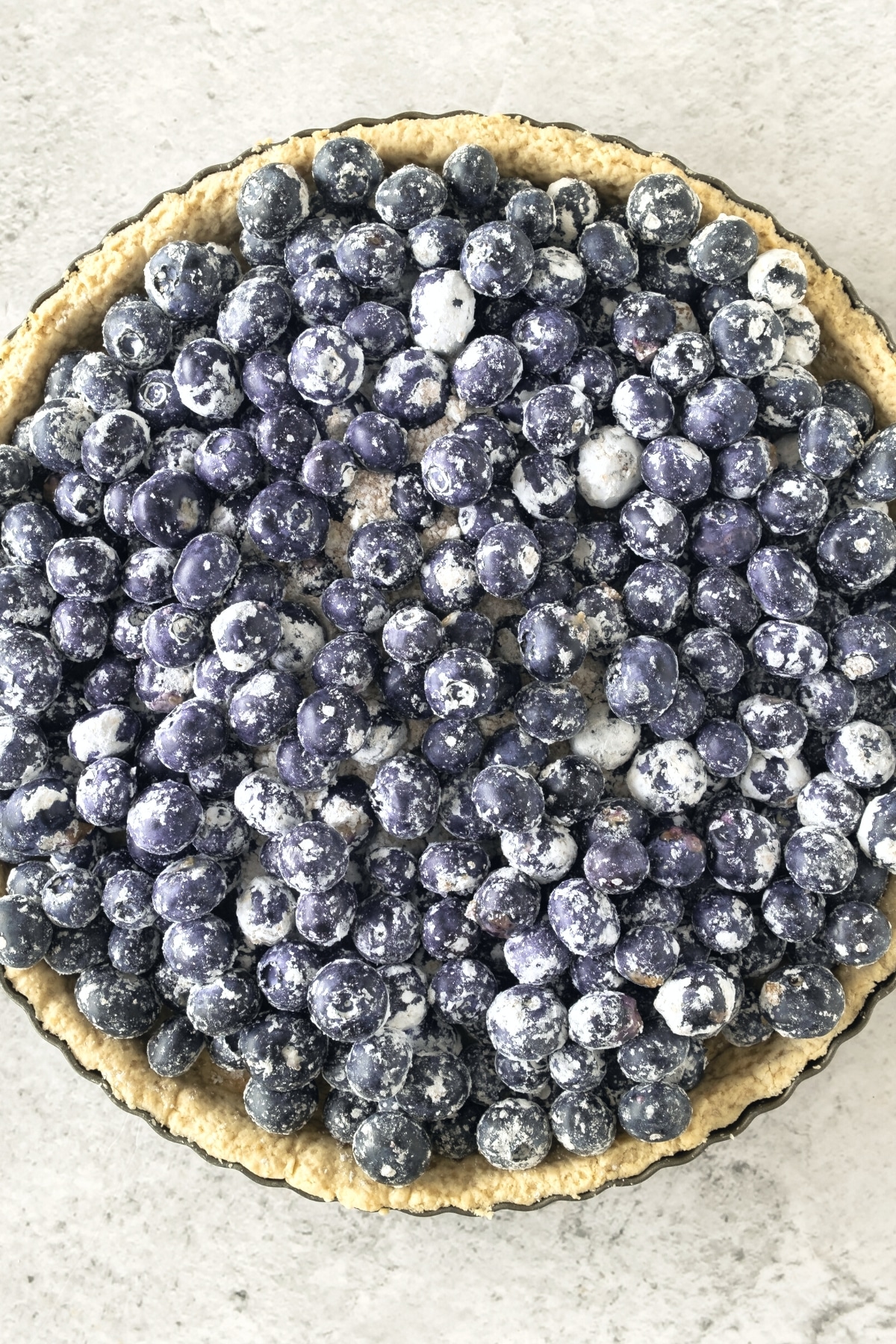 Fresh blueberry pie filling in pie pan.