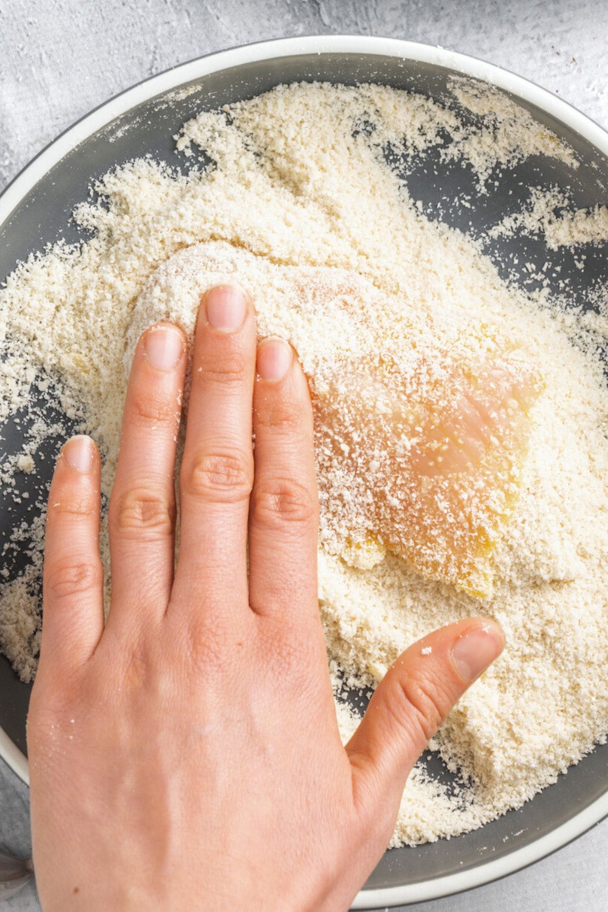 Coating chicken fillet in breadcrumb mixture