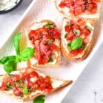 Tomato basil bruschetta on serving plate.