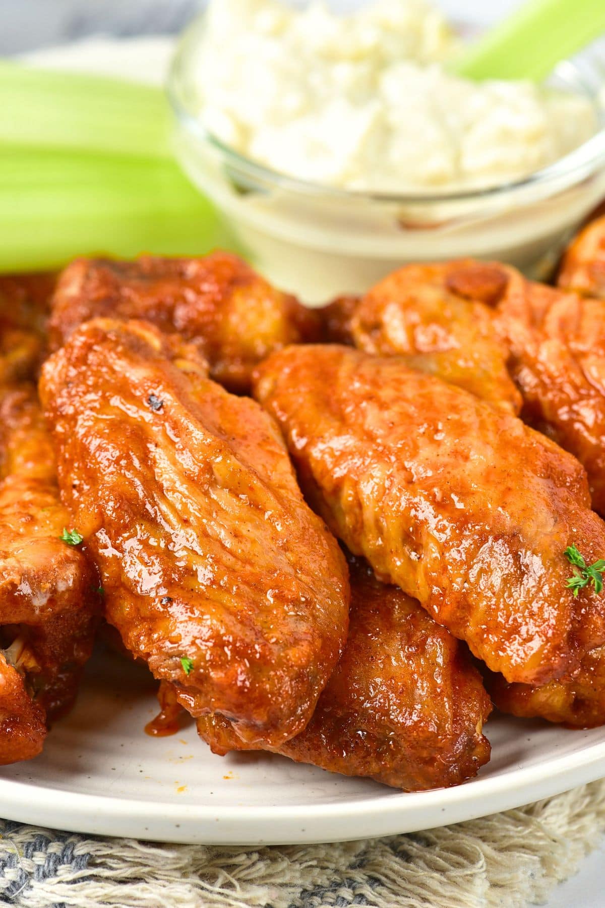 Up close view of gluten-free buffalo chicken wings on plate.