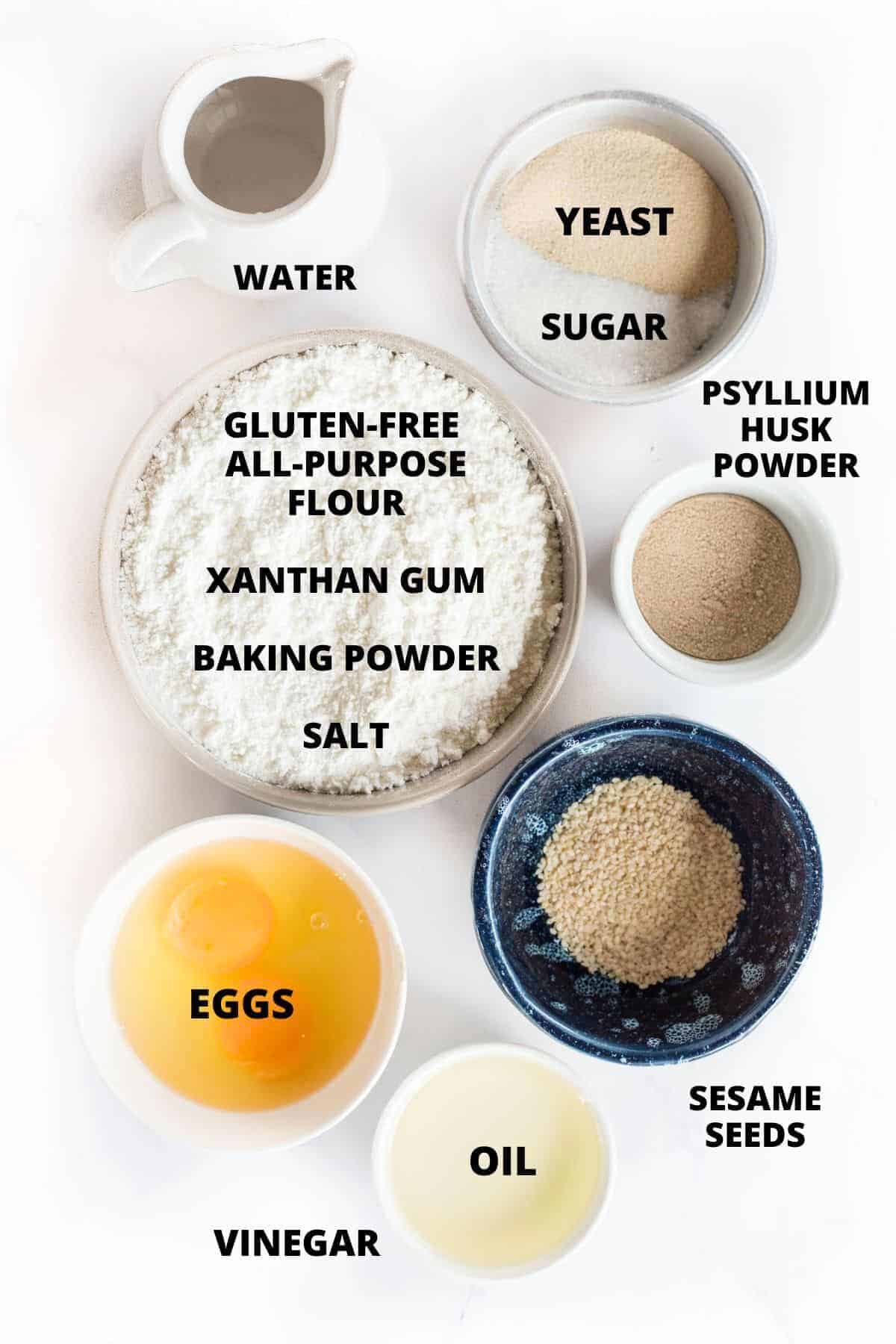 Ingredients for gluten-free hamburger bun recipe laid out on marble board.