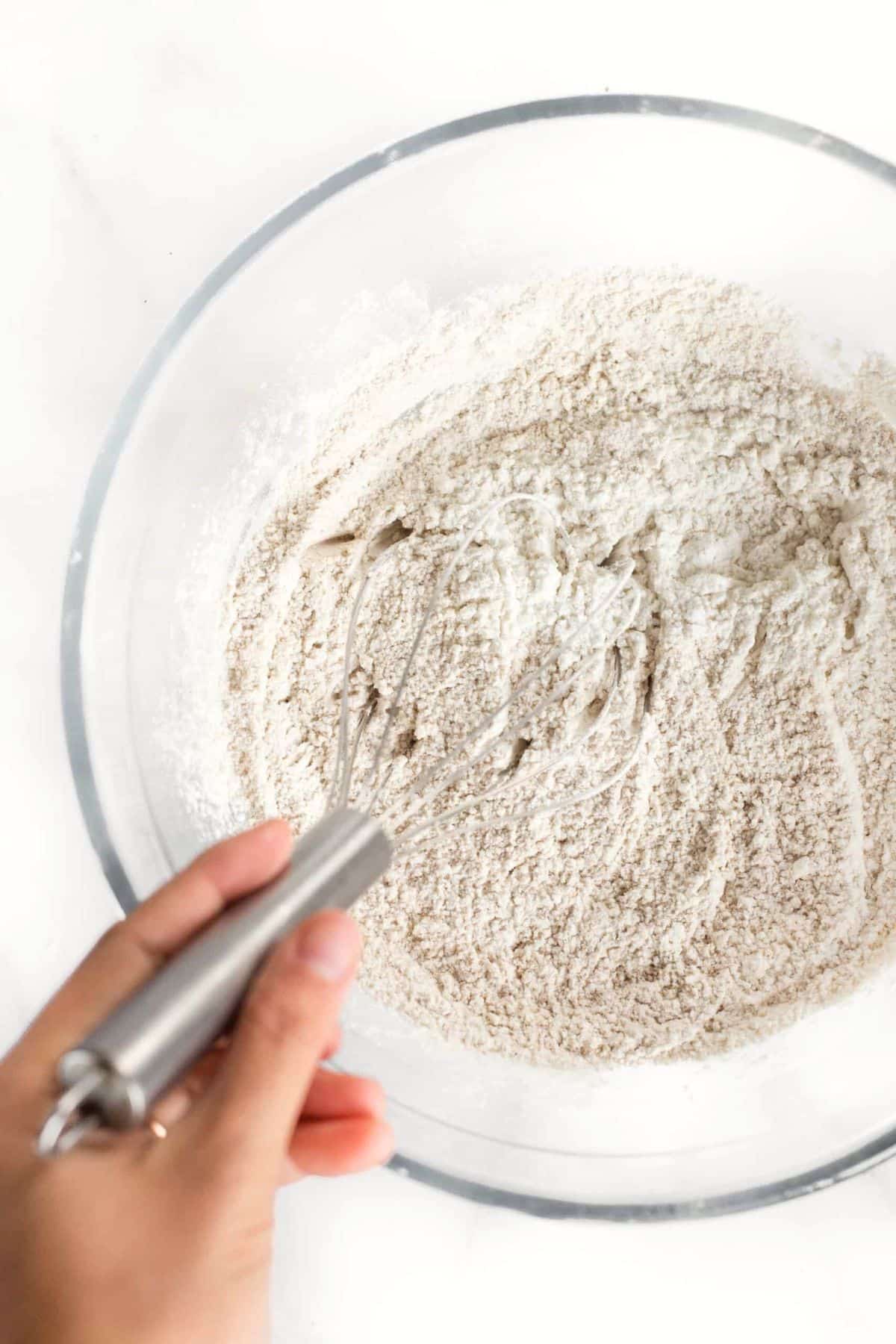 Whisking flour mixture in glass bowl.