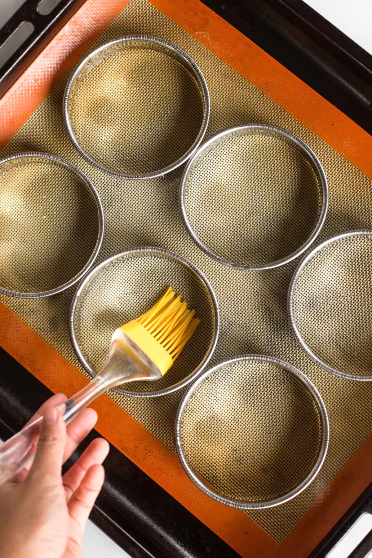 Brushing metal rings with silicon brush.
