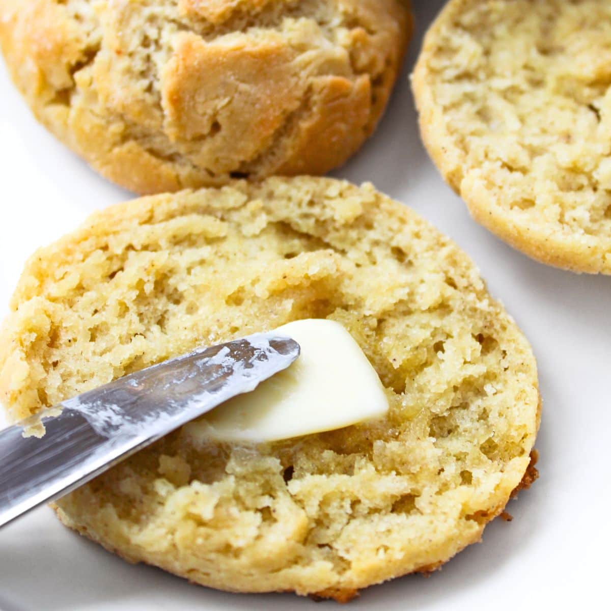 Spreading buttermilk biscuit with butter
