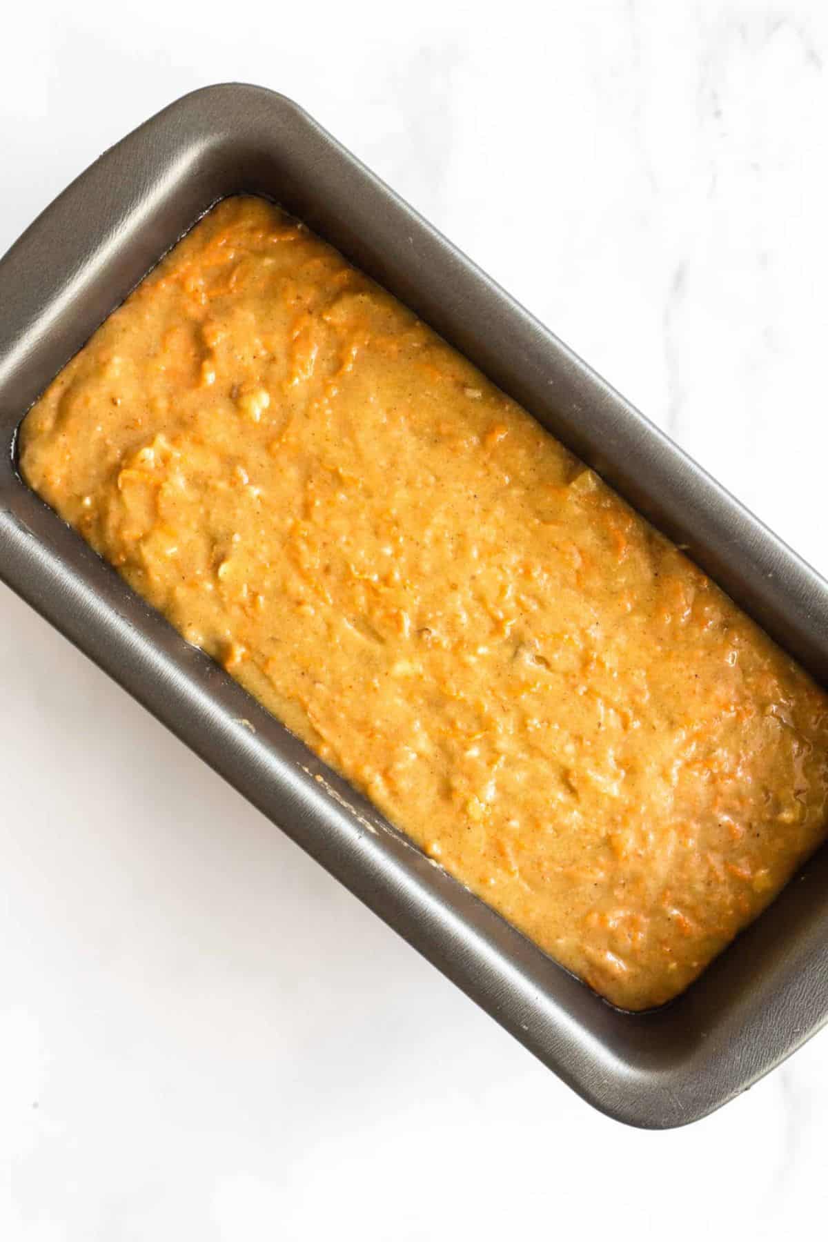 Carrot cake bread batter in loaf pan.