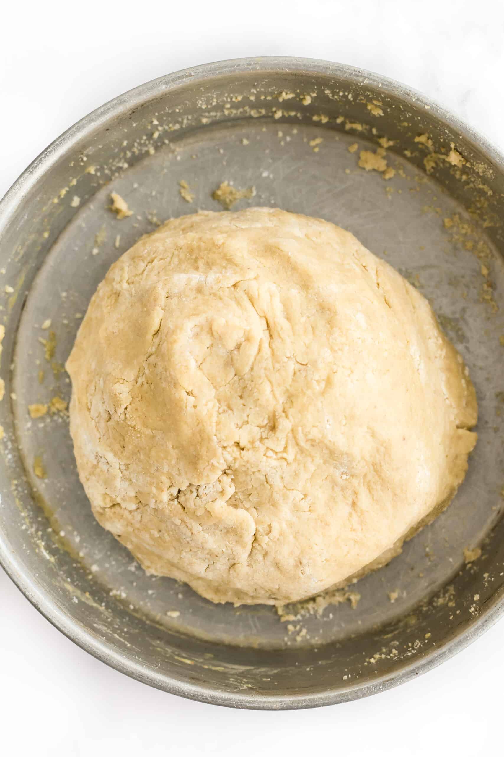 Cashew cookie dough in a metal bowl.