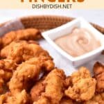 GF chicken fingers and a bowl of sauce on parchment-lined basket.