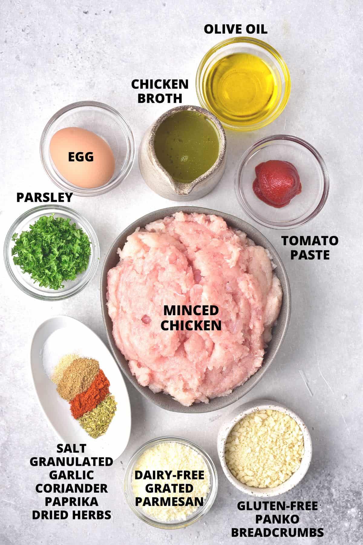 Ingredients for gluten-free chicken meatballs laid out on board.