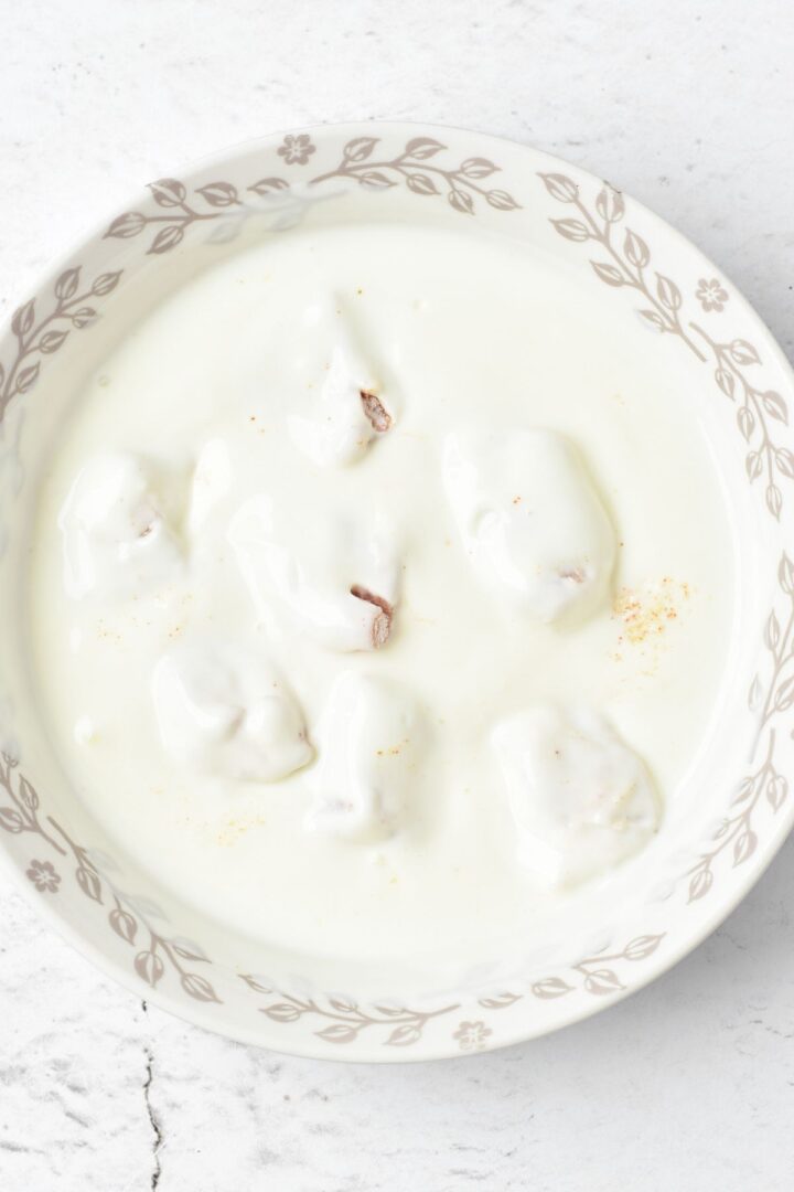 Dredging chicken cubes in buttermilk