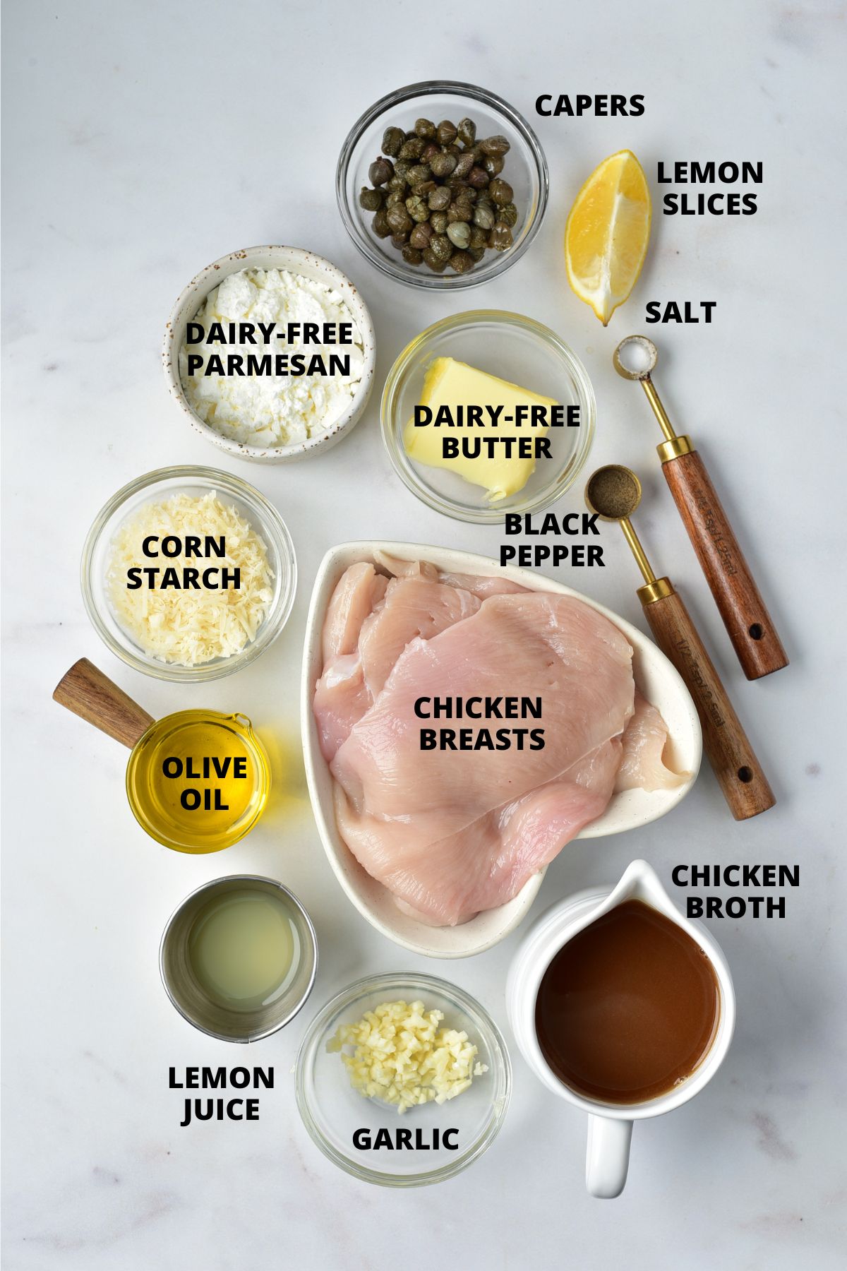 Ingredients for gluten-free chicken piccata recipe laid out on marble board