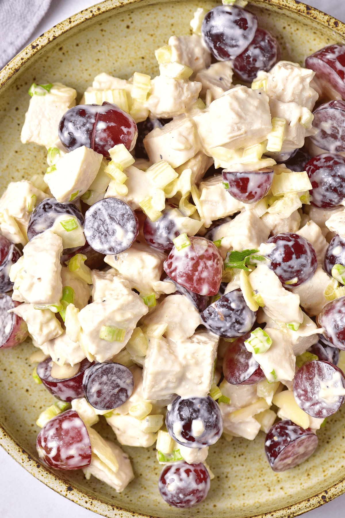 Top down view of gluten-free dairy-free chicken salad on a green plate.