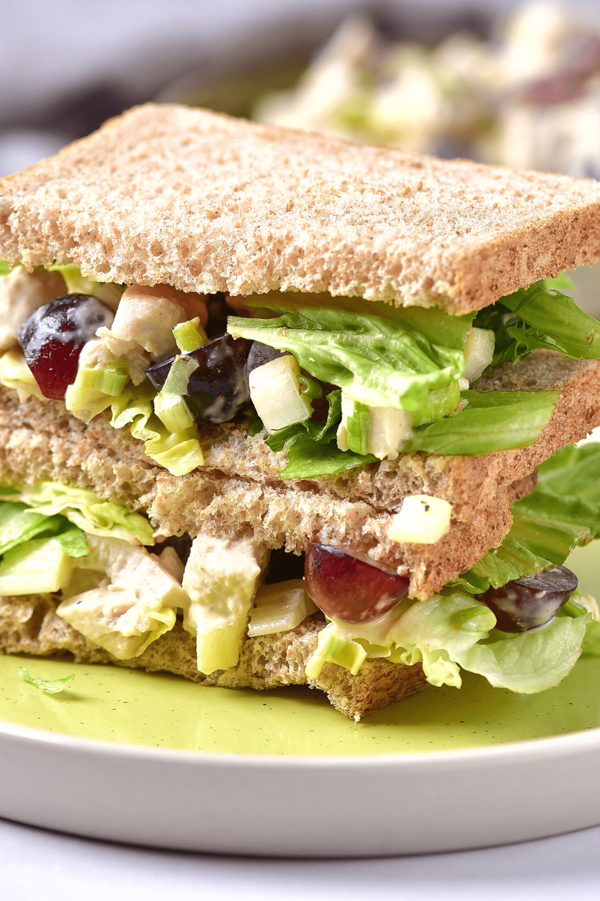 A gluten-free chicken salad sandwich on a plate.