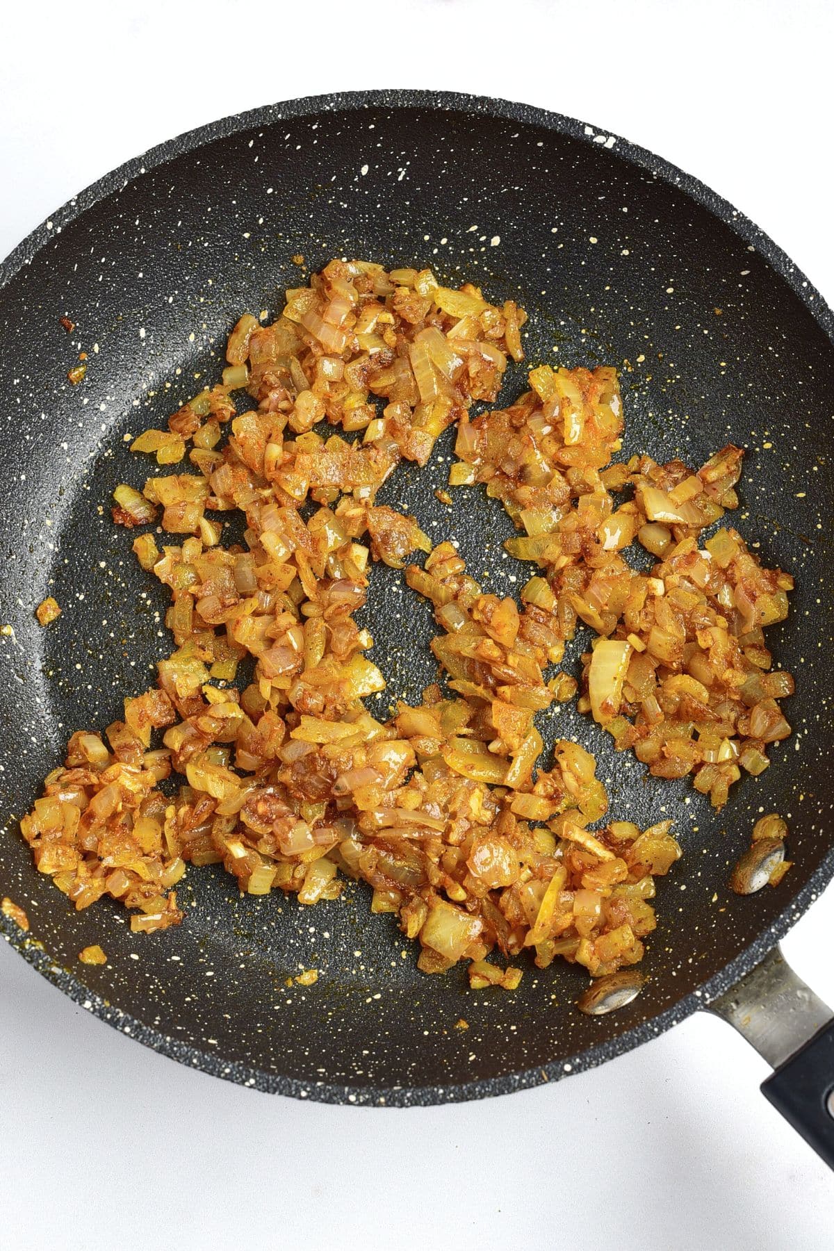 Sautéed onions, garlic and spices in skillet.