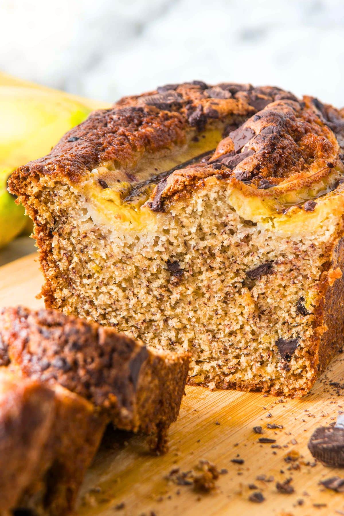 Half-sliced loaf of chocolate chip banana bread (gluten-free).
