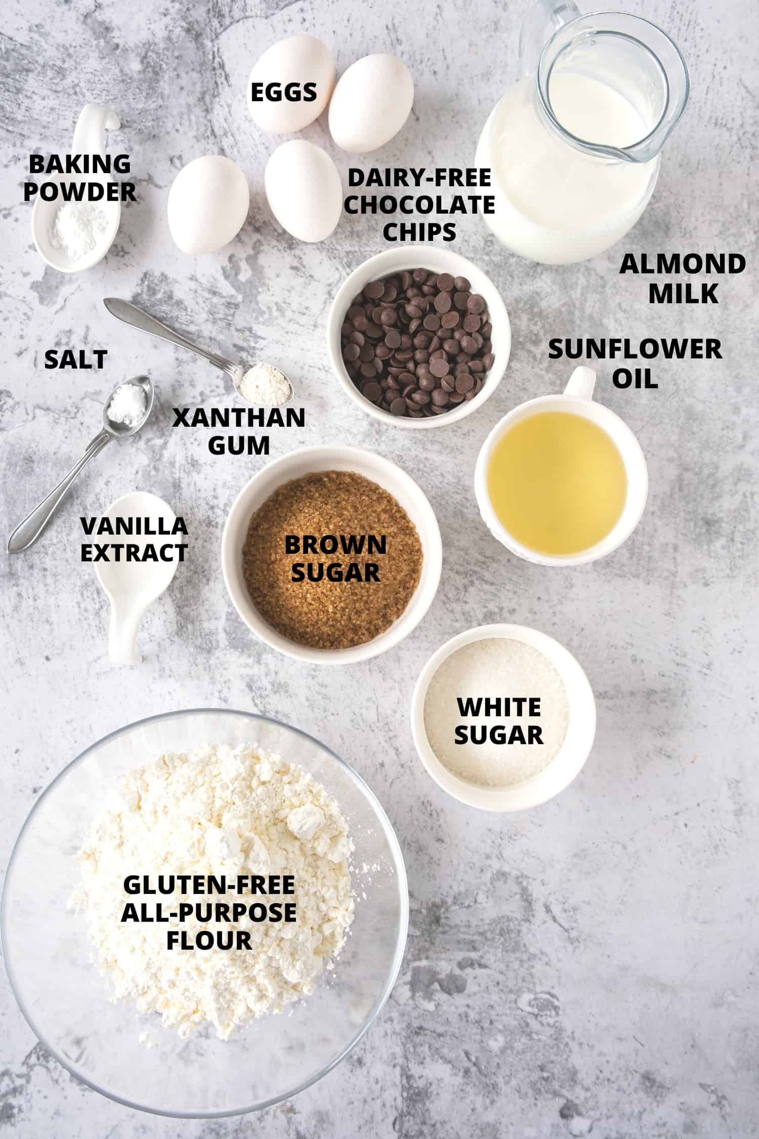 Ingredients for gluten-free chocolate chip muffins laid out on board.