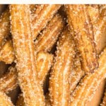 Up close view of gluten-free churros coated in sugar.