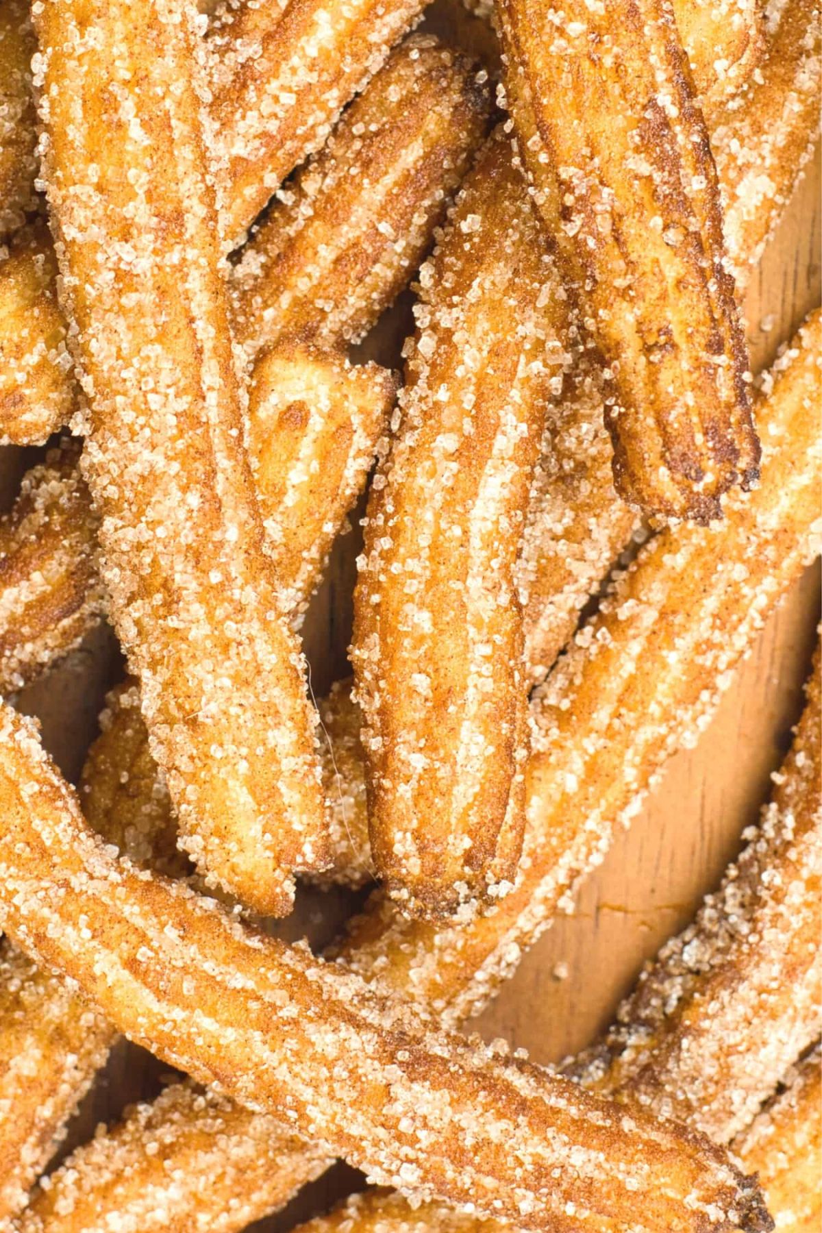 Top down view of gluten-free vegan churros on wooden board.