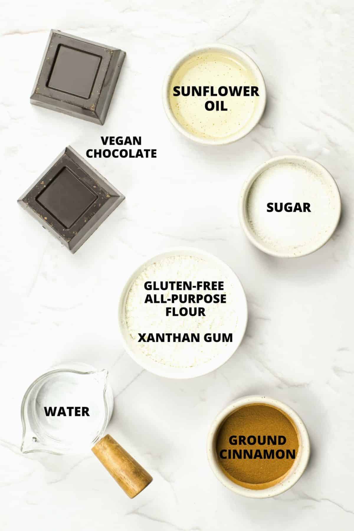 Ingredients required for gluten-free churros recipe laid out on marble board.