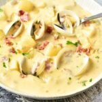 A bowl of clam chowder on kitchen towel