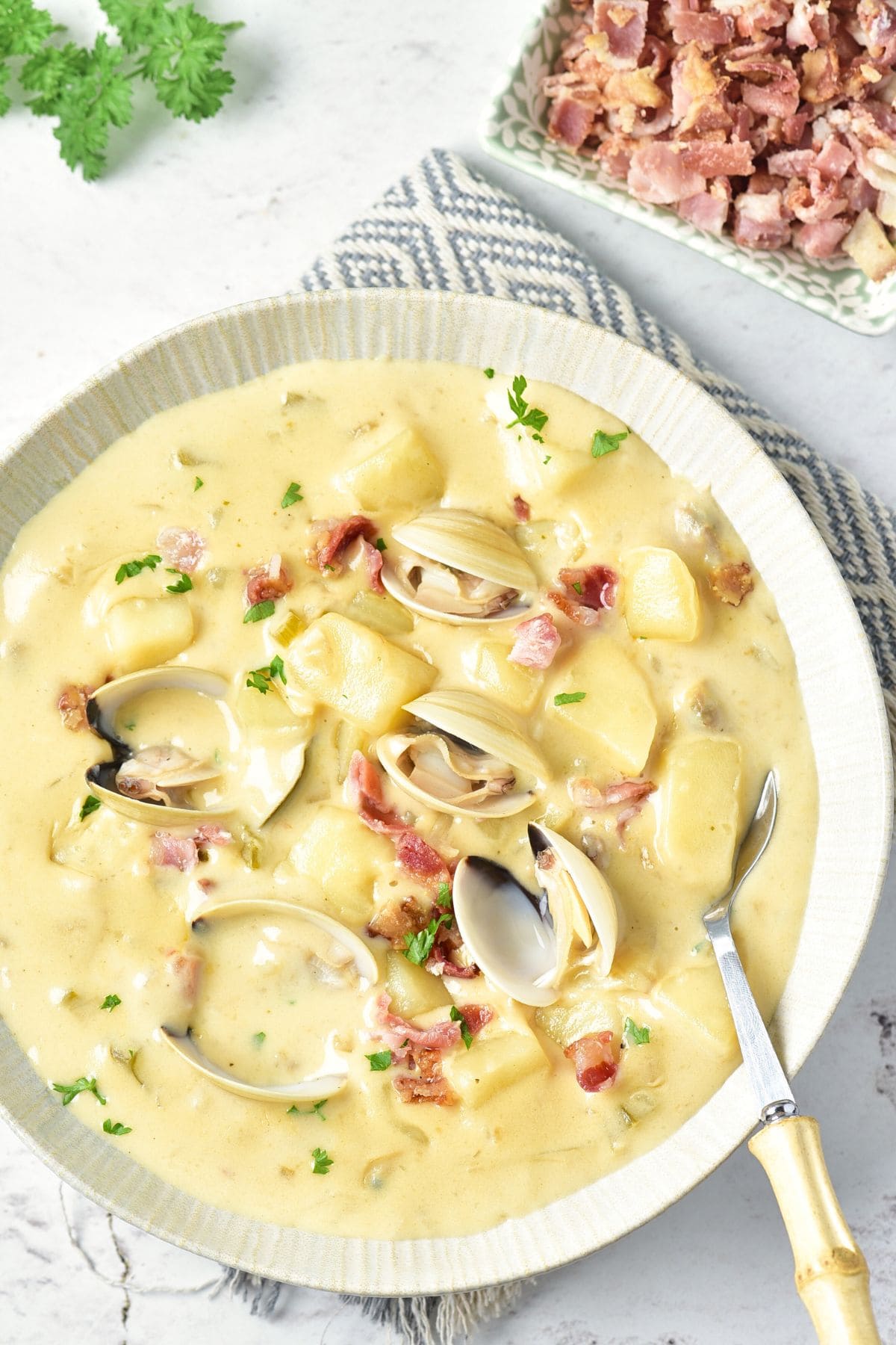 Top down view of a bowl of gluten-free New England clam chowder.