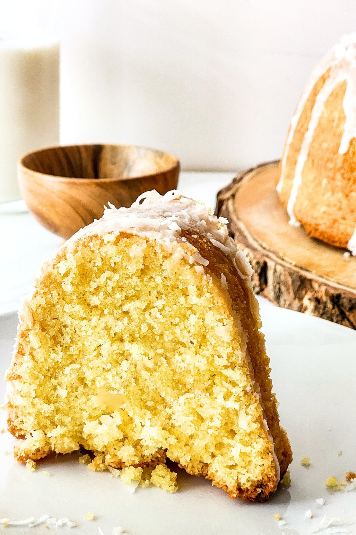 A slice of coconut cake on plate.