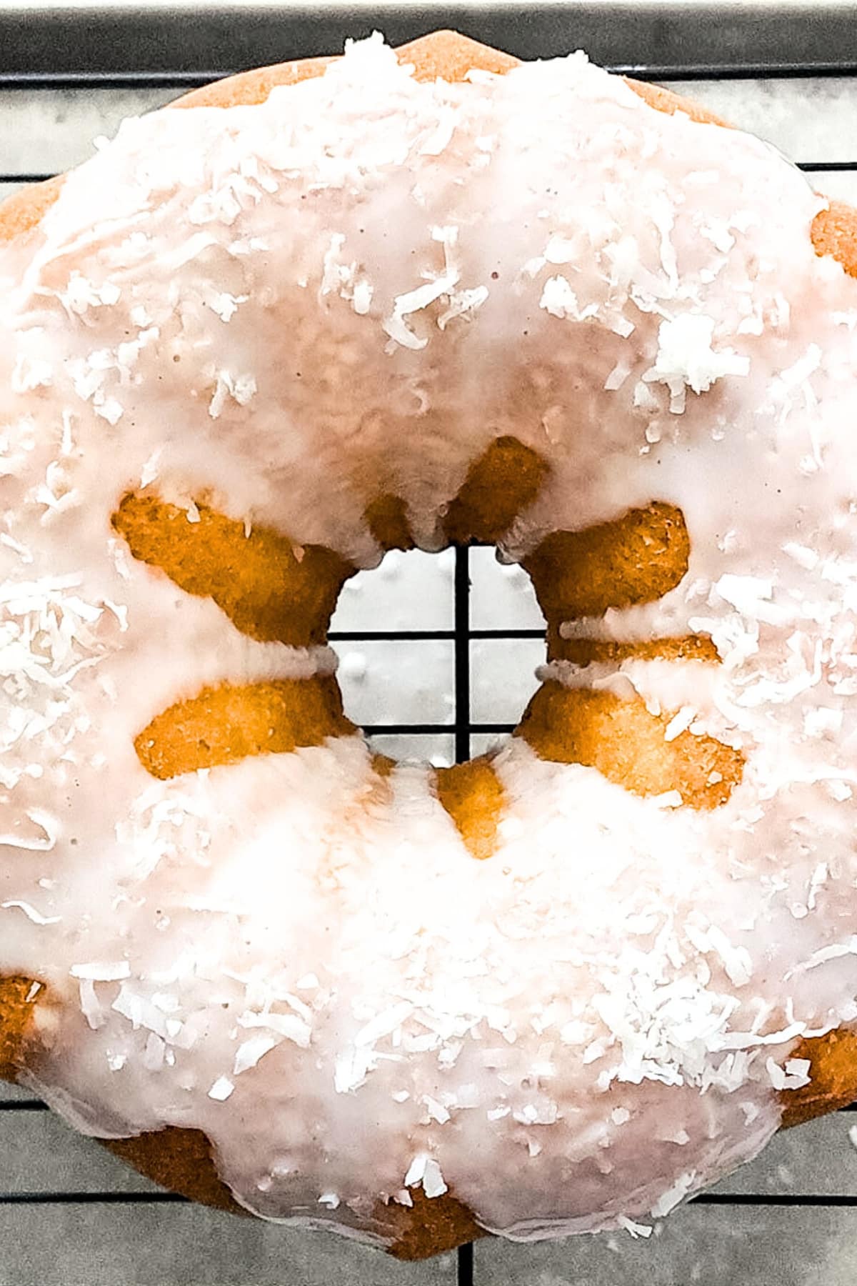 Coconut cake drizzled in glaze and sprinkled with shredded coconut.
