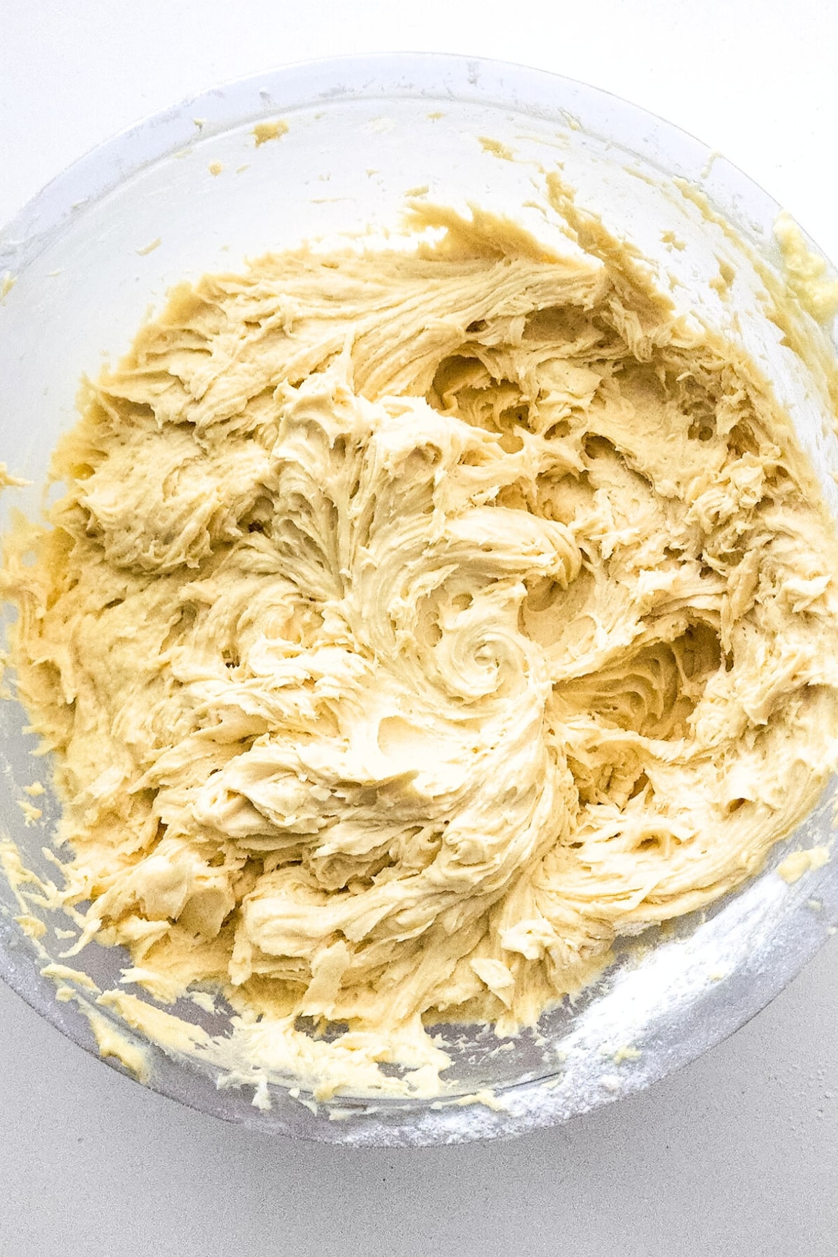 Coconut cake batter in glass bowl.
