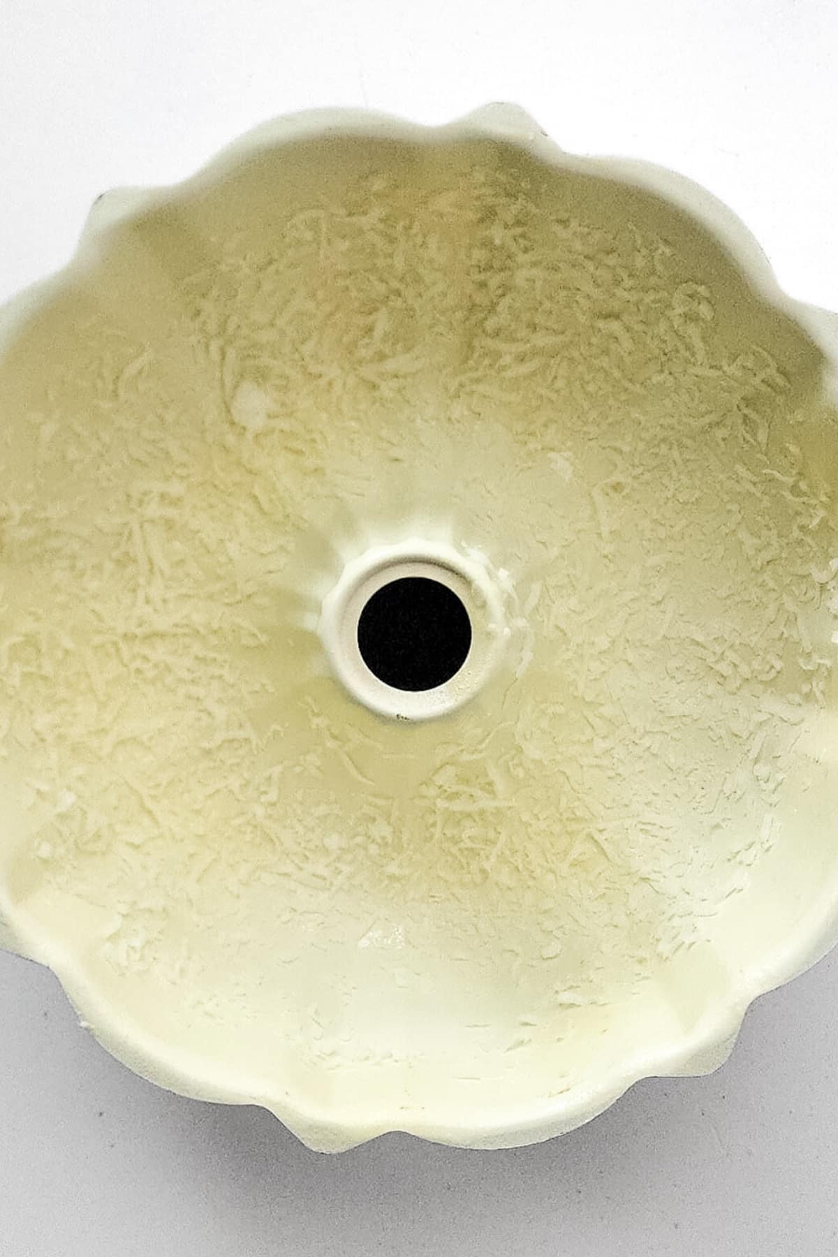 Bundt pan coated with shredded coconut.