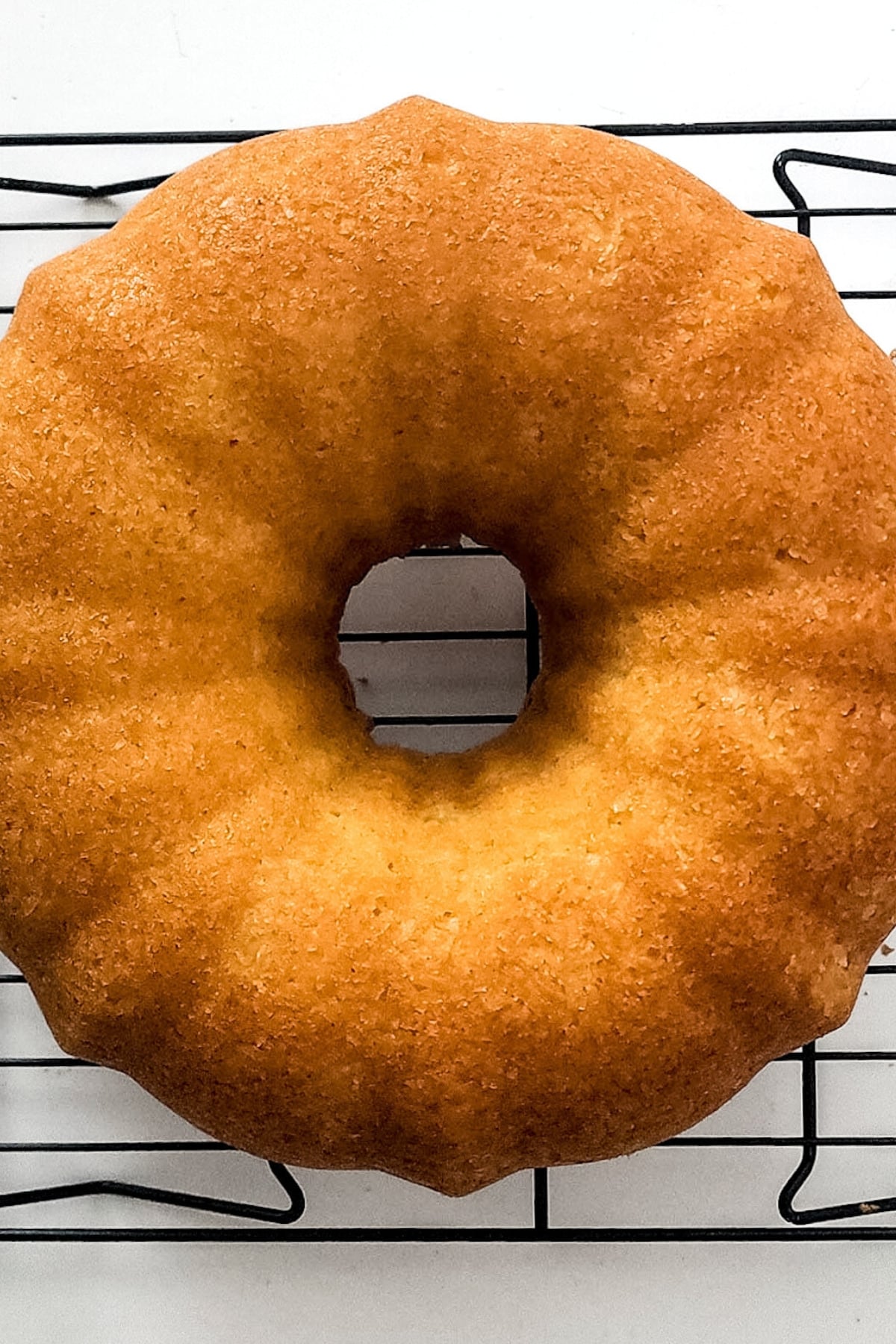 Top down view of bundt cake on wire rack.