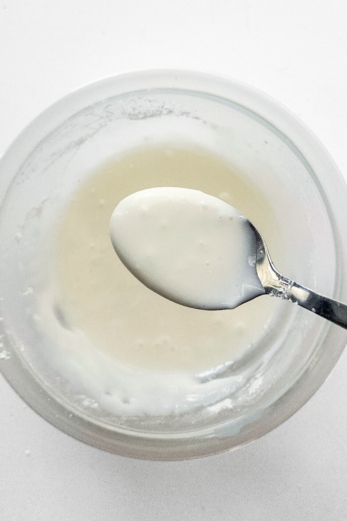 Holding up a spoonful of coconut glaze.