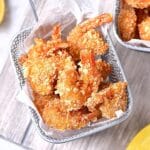 Top down view of a basket of coconut shrimp