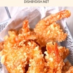 Top down view of coconut shrimp in metal basket.