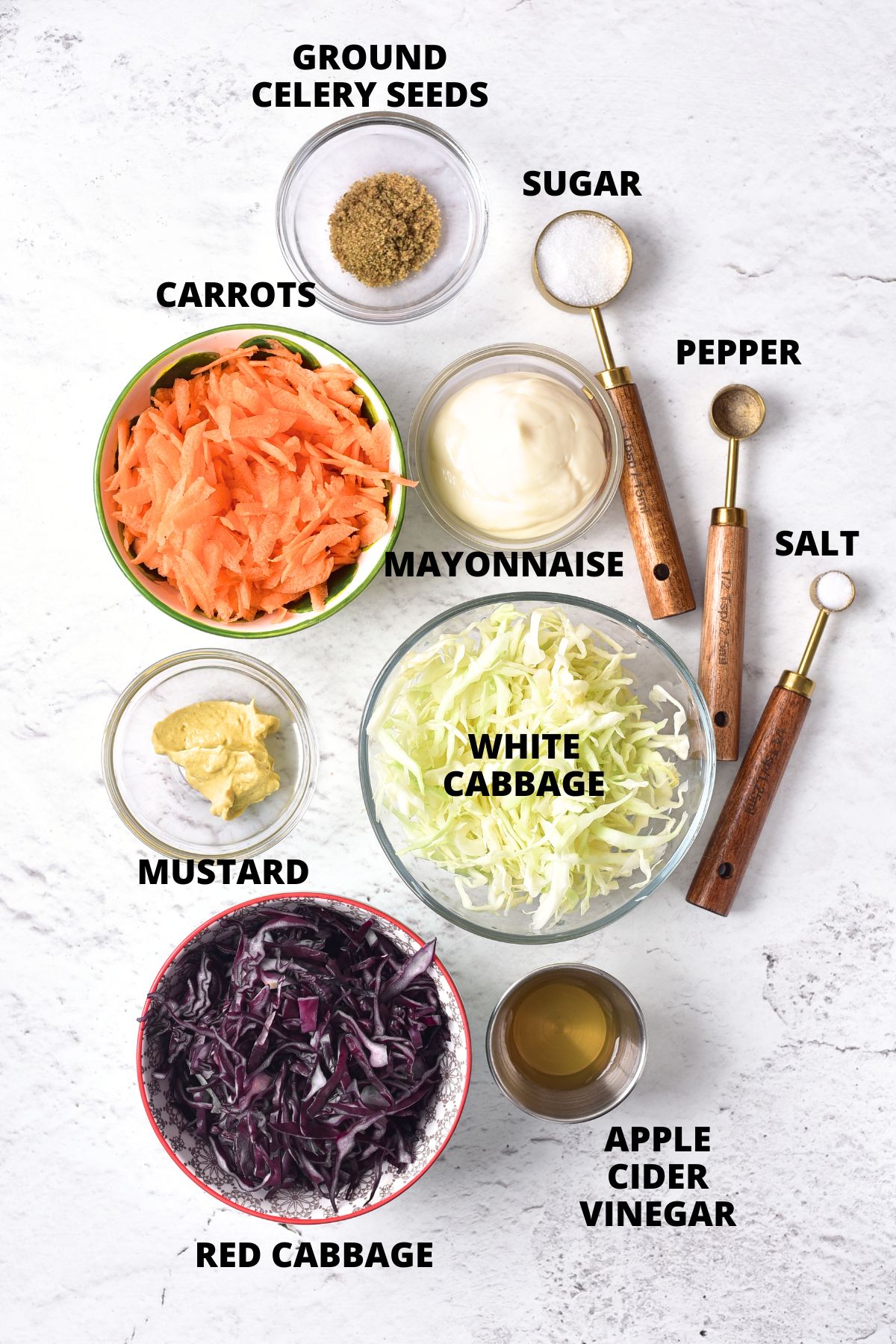 Ingredients for gluten-free coleslaw recipe laid out on marble board.