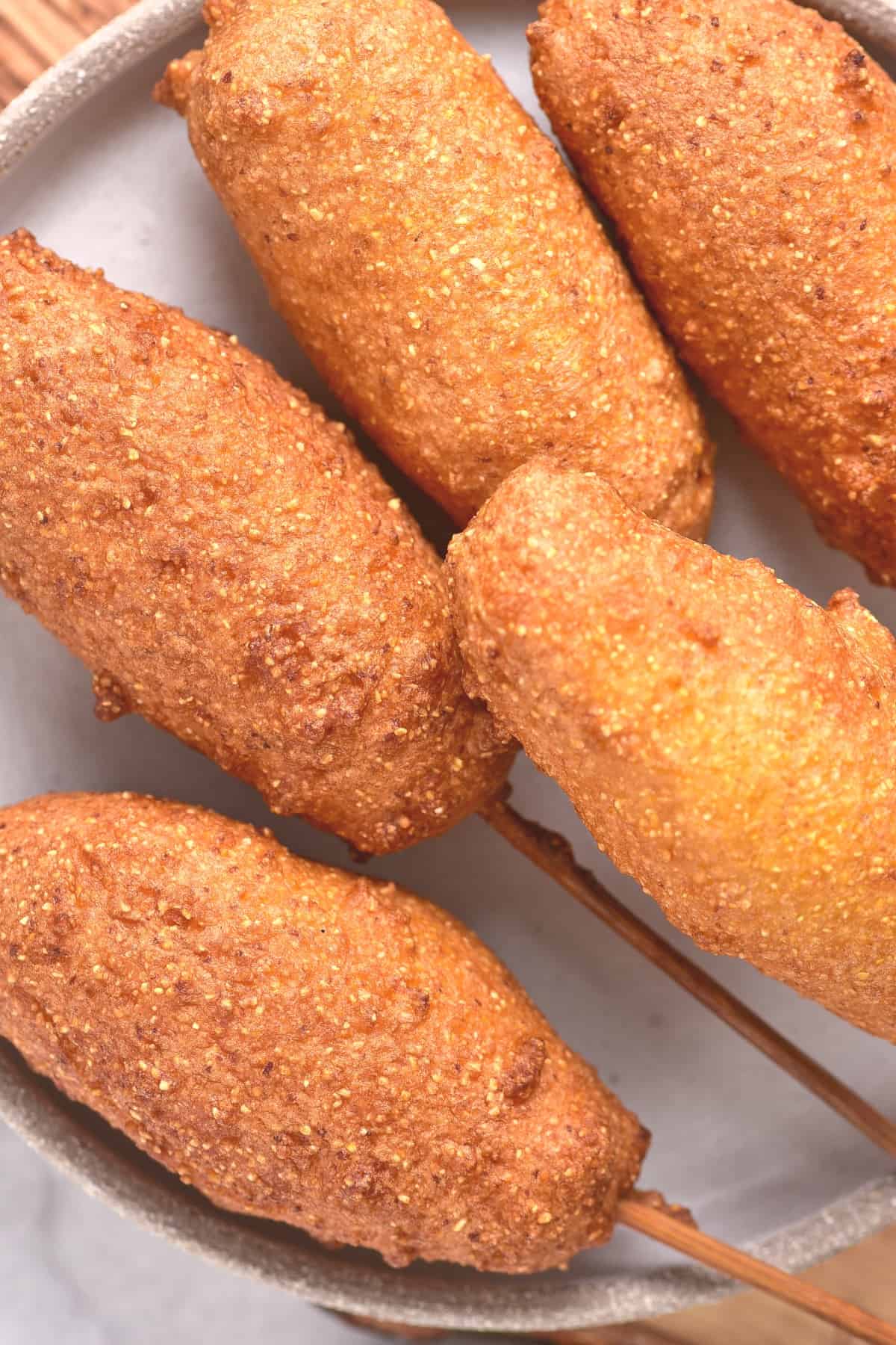 Top down view of gluten-free corn dog on a plate.