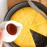 Pouring honey over skillet cornbread