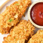 Top down view of cornflake chicken tenders on plate