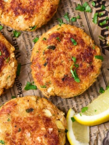 Top down view of gluten-free crab cakes on newspaper.