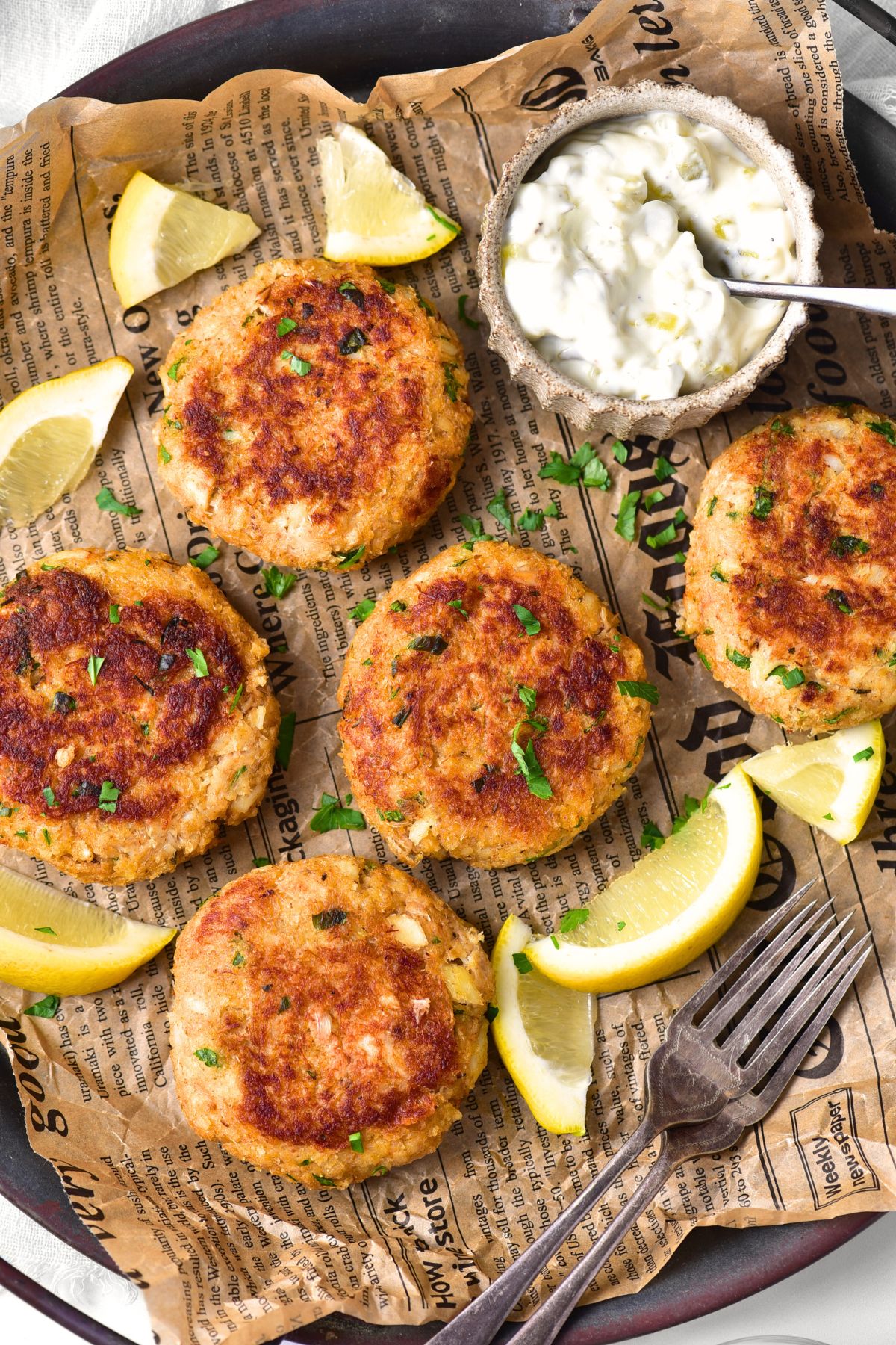 Top down view of gluten-free dairy-free crab cakes on newspaper.