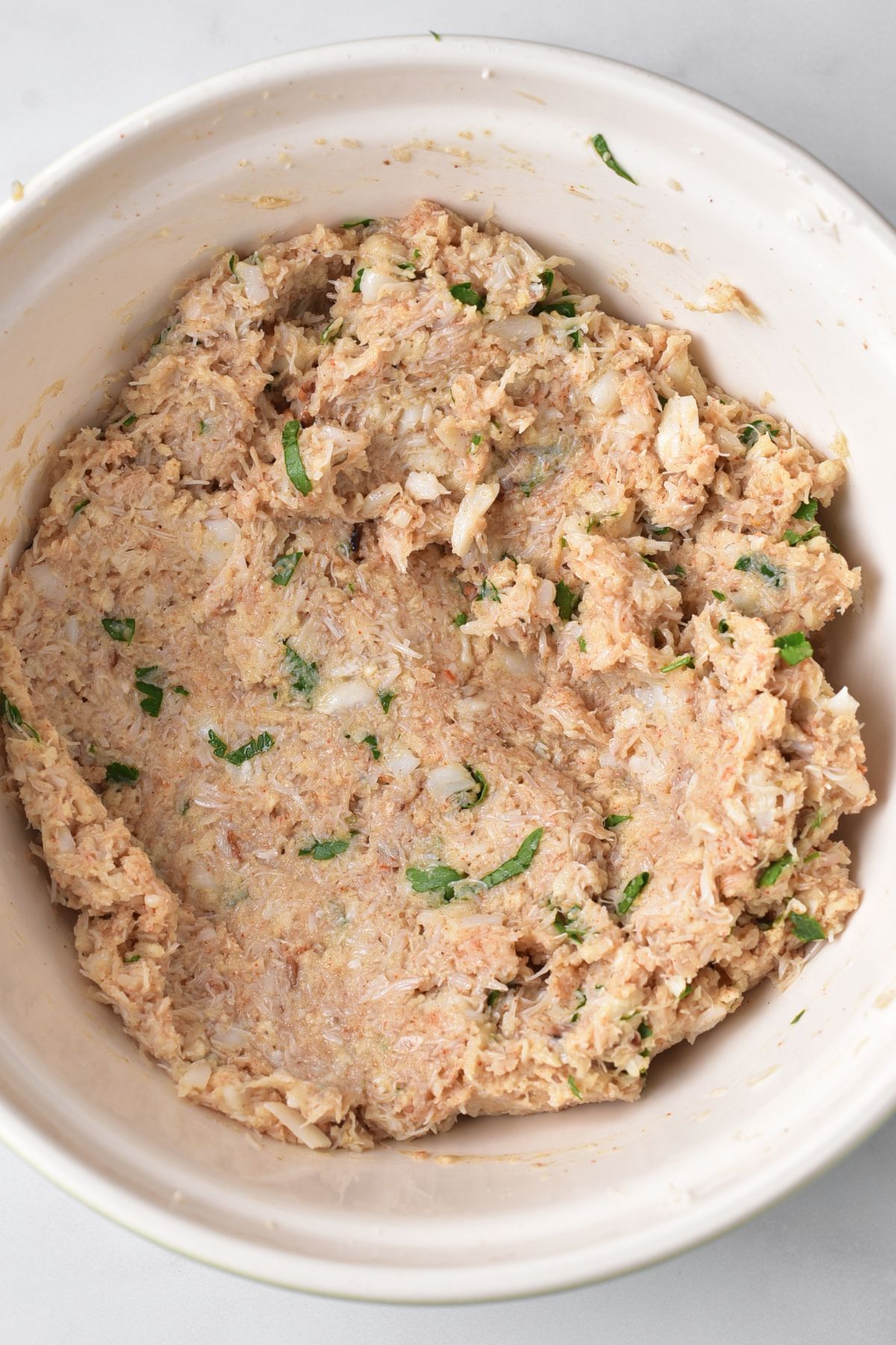 A bowl of crab meat mixture.