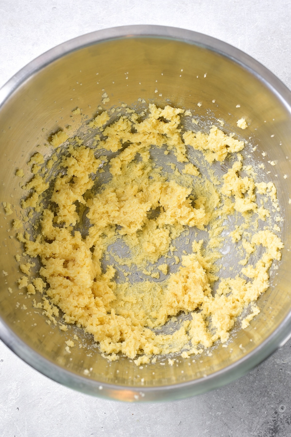 Butter and sugar mixture in metal mixing bowl.