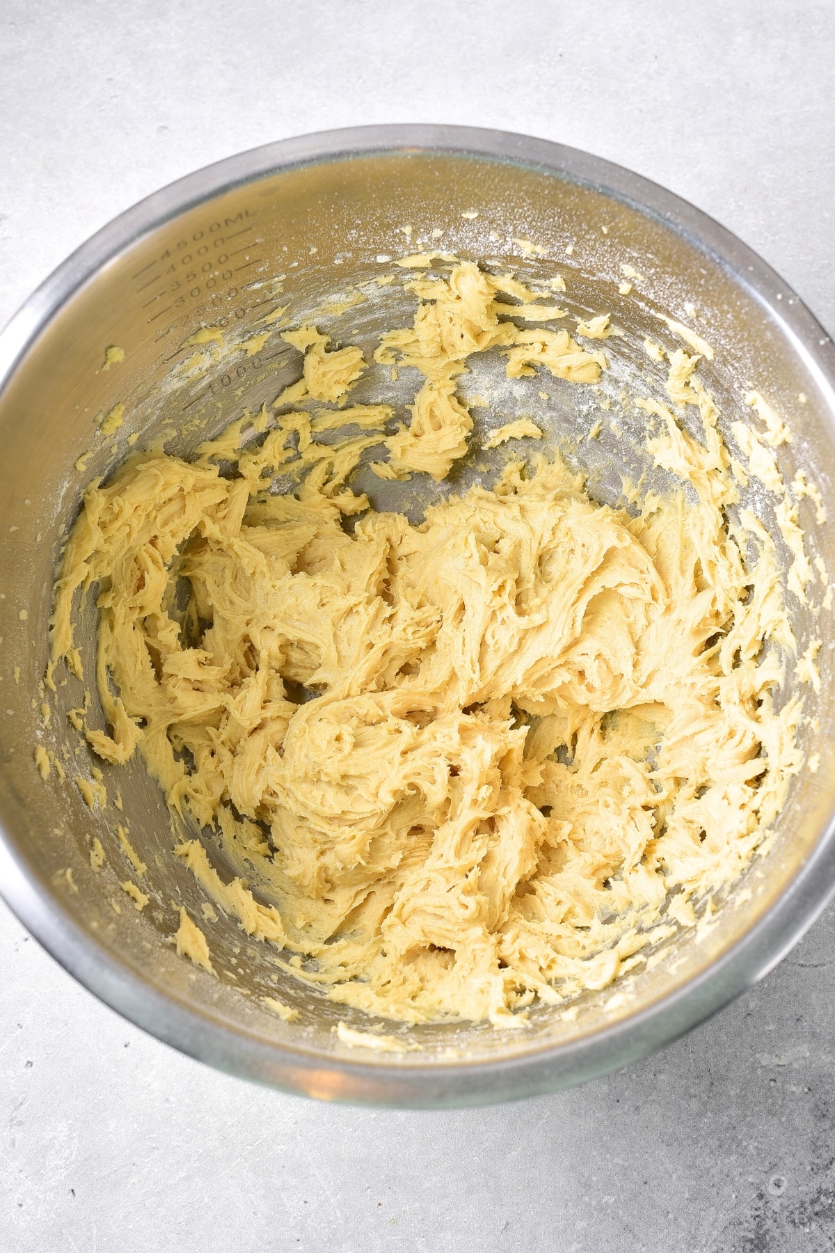 Yellow batter in metal bowl.