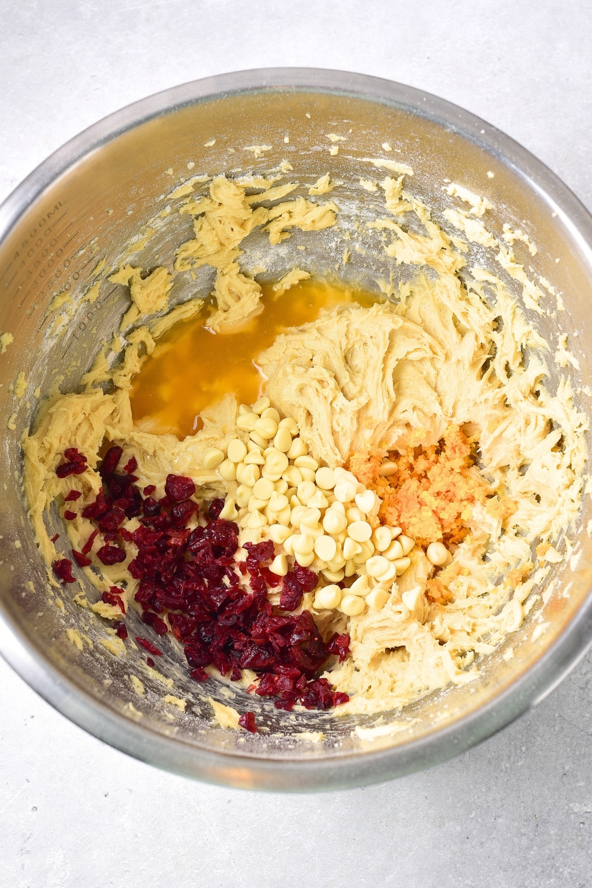 Dried cranberries, white chocolate chips and orange juice on top of cake batter.