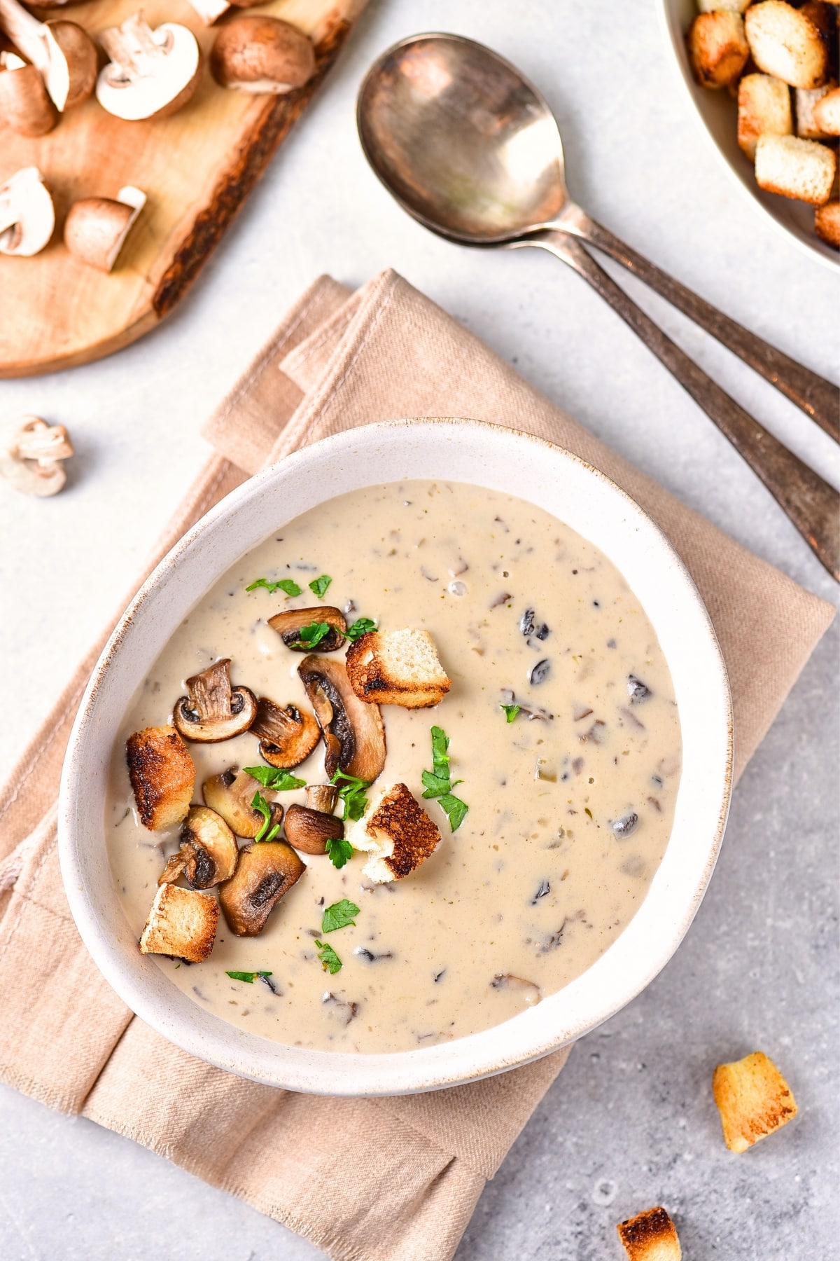 A bowl of gluten-free dairy-free cream. of mushroom soup on kitchen towel.