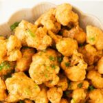 A big bowl of crispy fried cauliflower bites.