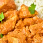 a bowl od chicken in creamy tomato sauce and rice